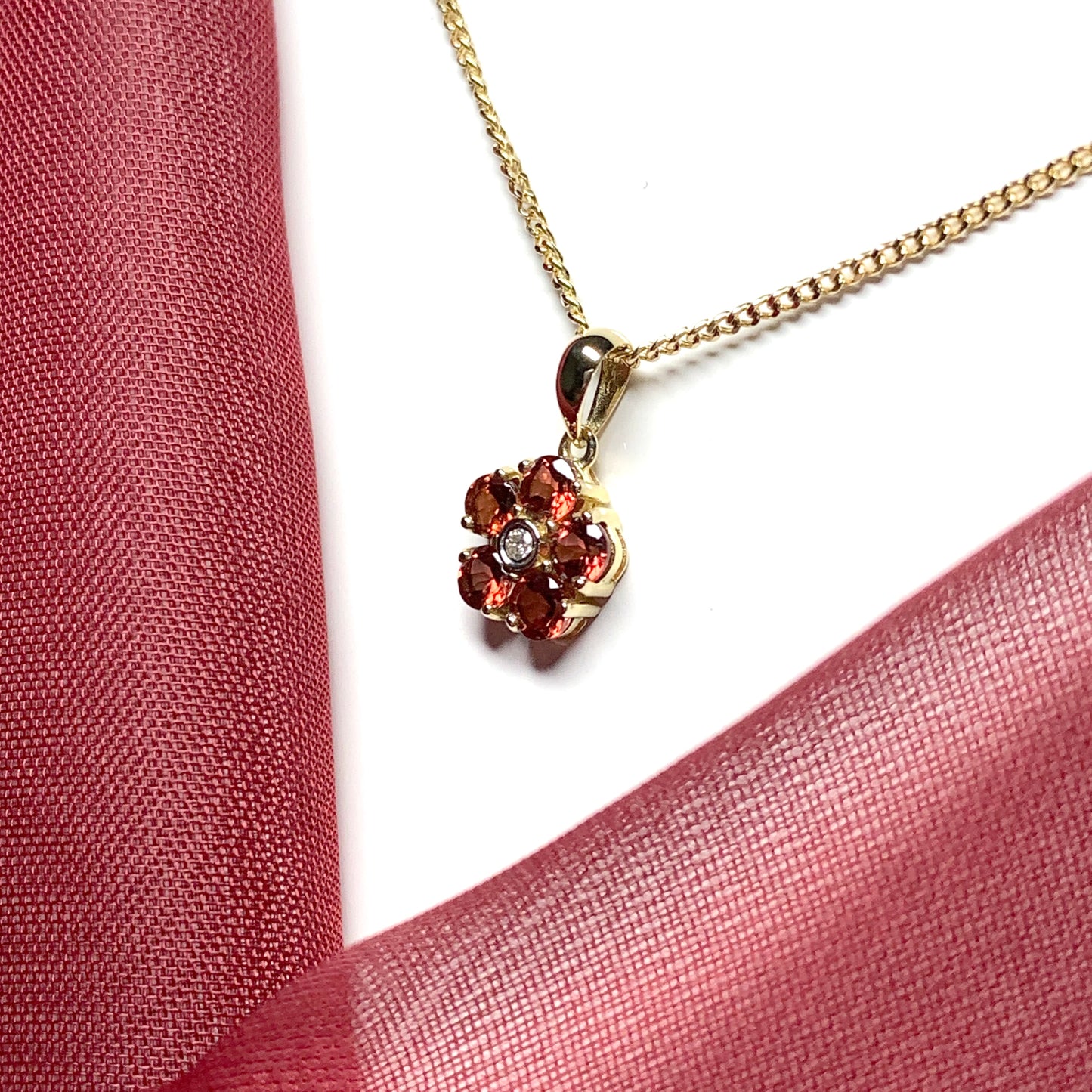 Red brown garnet and diamond yellow gold daisy cluster necklace pendant