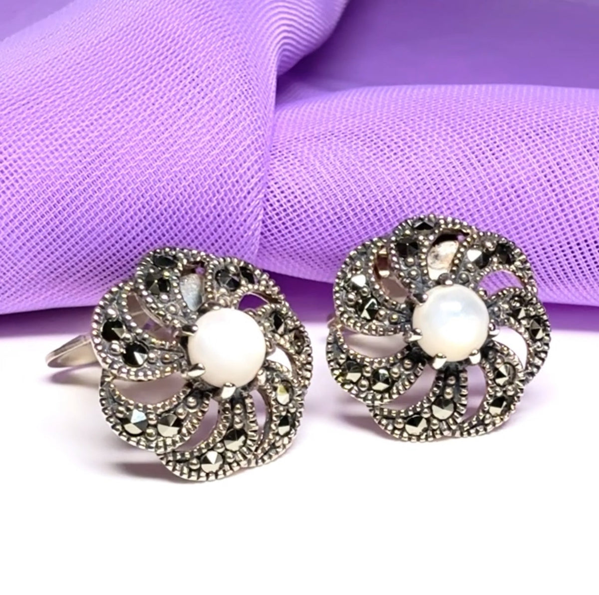 Round clip on earrings with marcasite and mother of pearl and sterling silver
