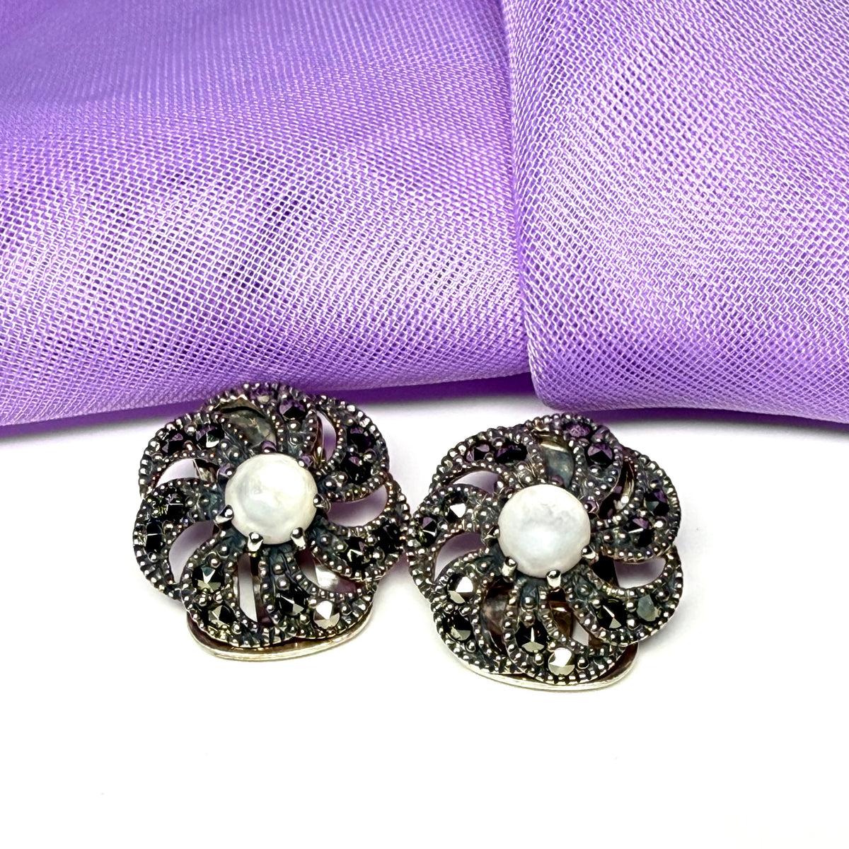 Round clip on earrings with marcasite and mother of pearl and sterling silver