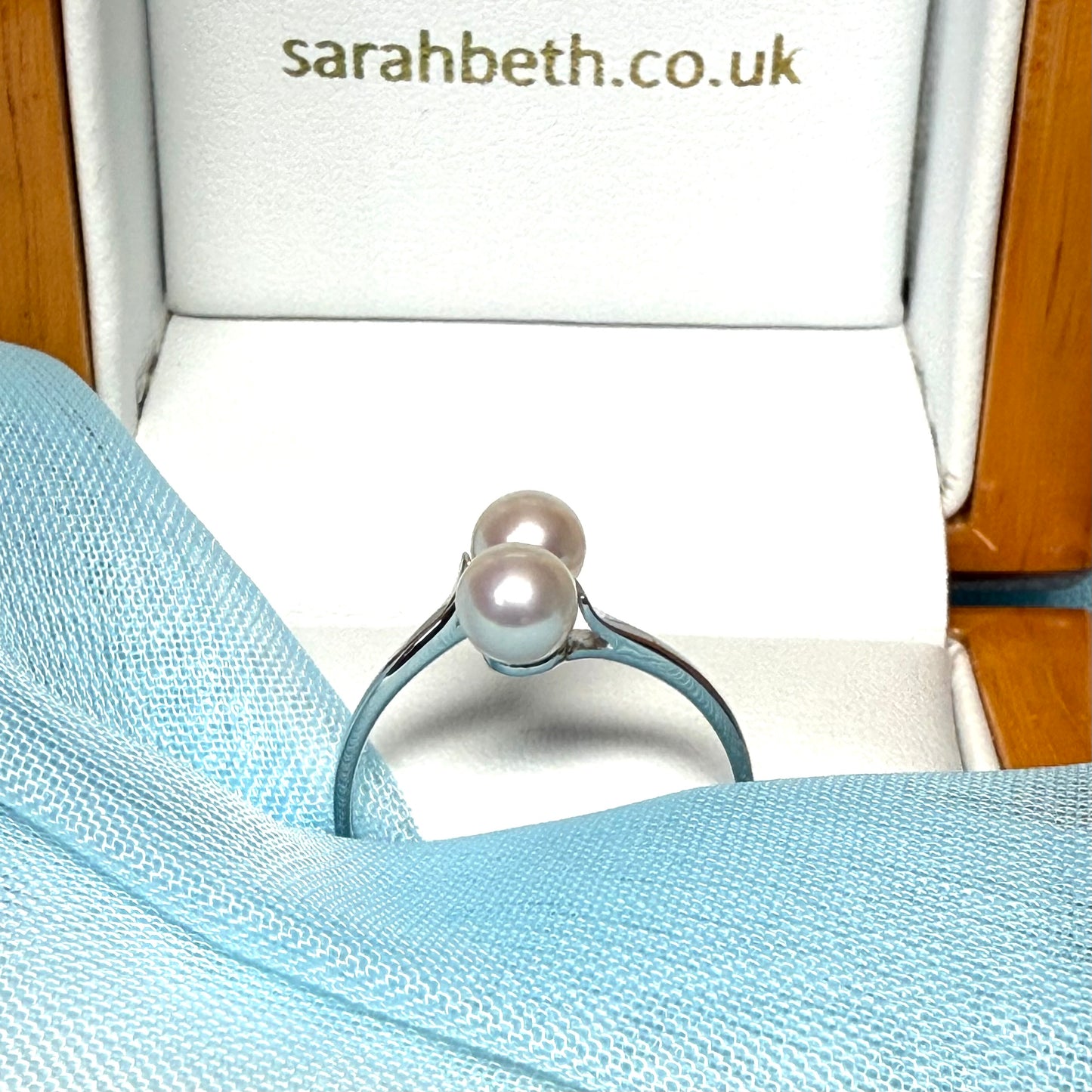 Round real cultured double pearl ring with a twisted design white gold