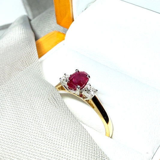 Ruby and diamond yellow gold three stone trilogy ring