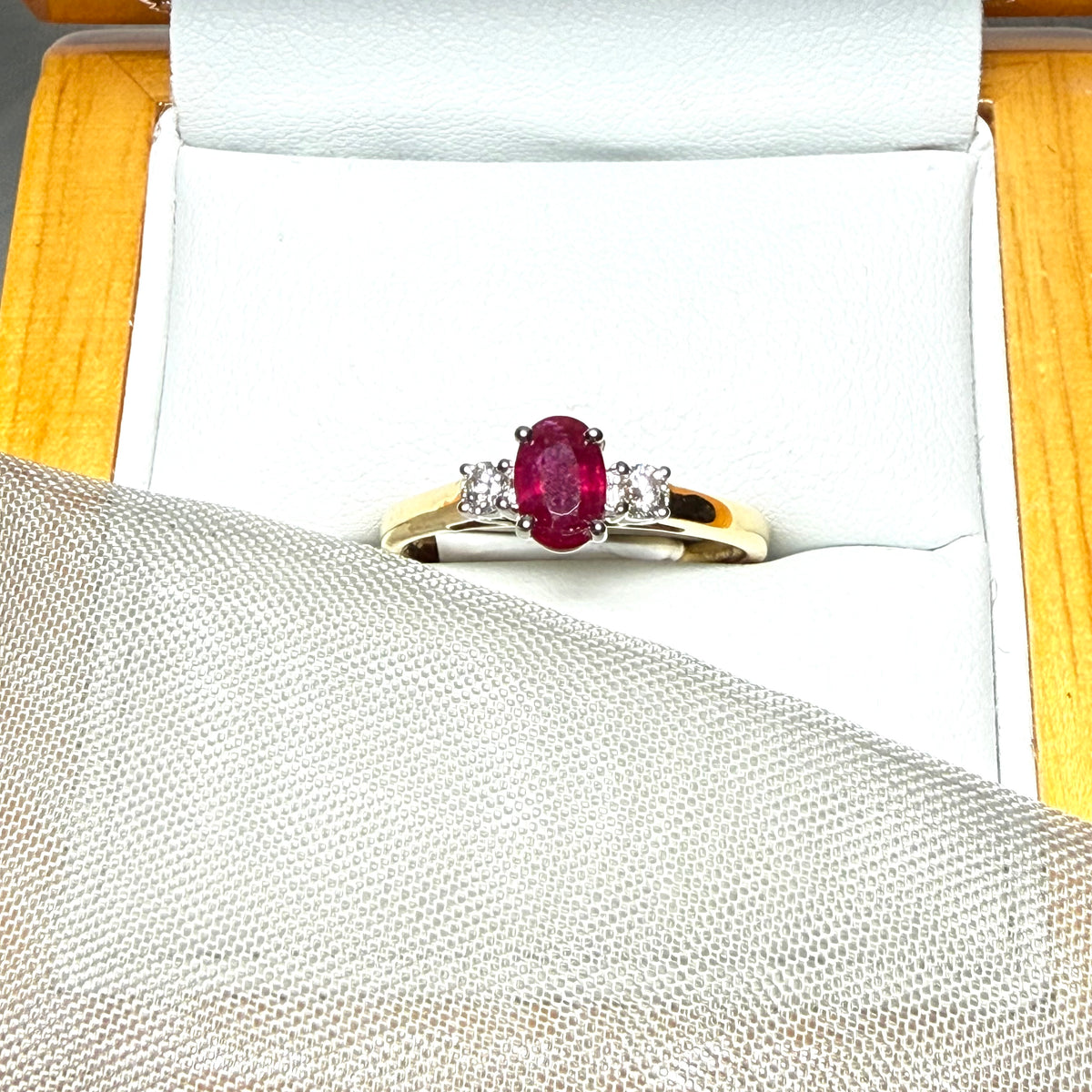 Ruby and diamond yellow gold three stone trilogy ring