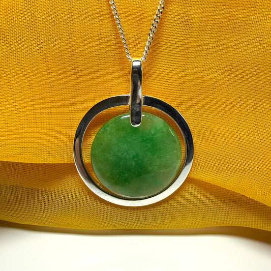 A shimmering large round halo necklace sterling silver circle shaped green real jade