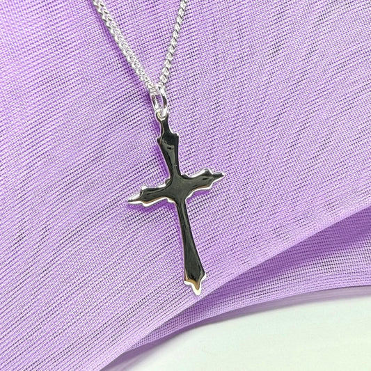A solid fancy shaped sterling silver cross necklace pendant with a chain included