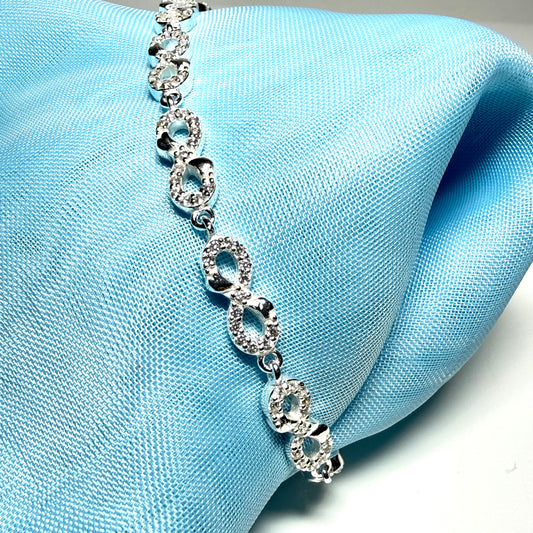 Sparkling infinity style shaped cubic zirconia sterling silver bracelet
