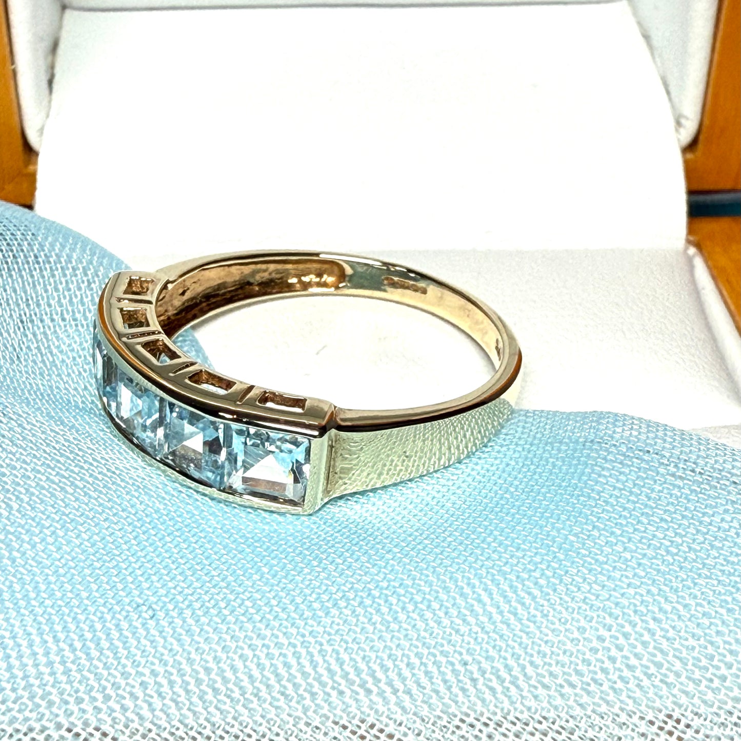 Square shaped real blue topaz yellow gold eternity ring smooth rubbed over invisible setting