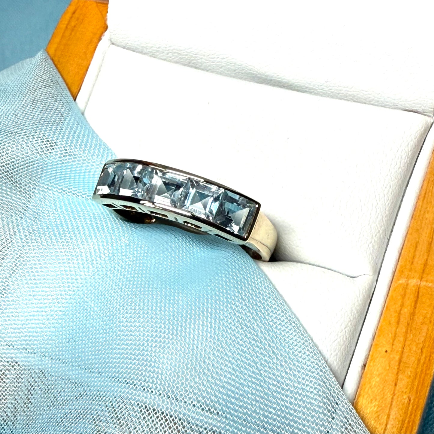 Square shaped real blue topaz yellow gold eternity ring smooth rubbed over invisible setting
