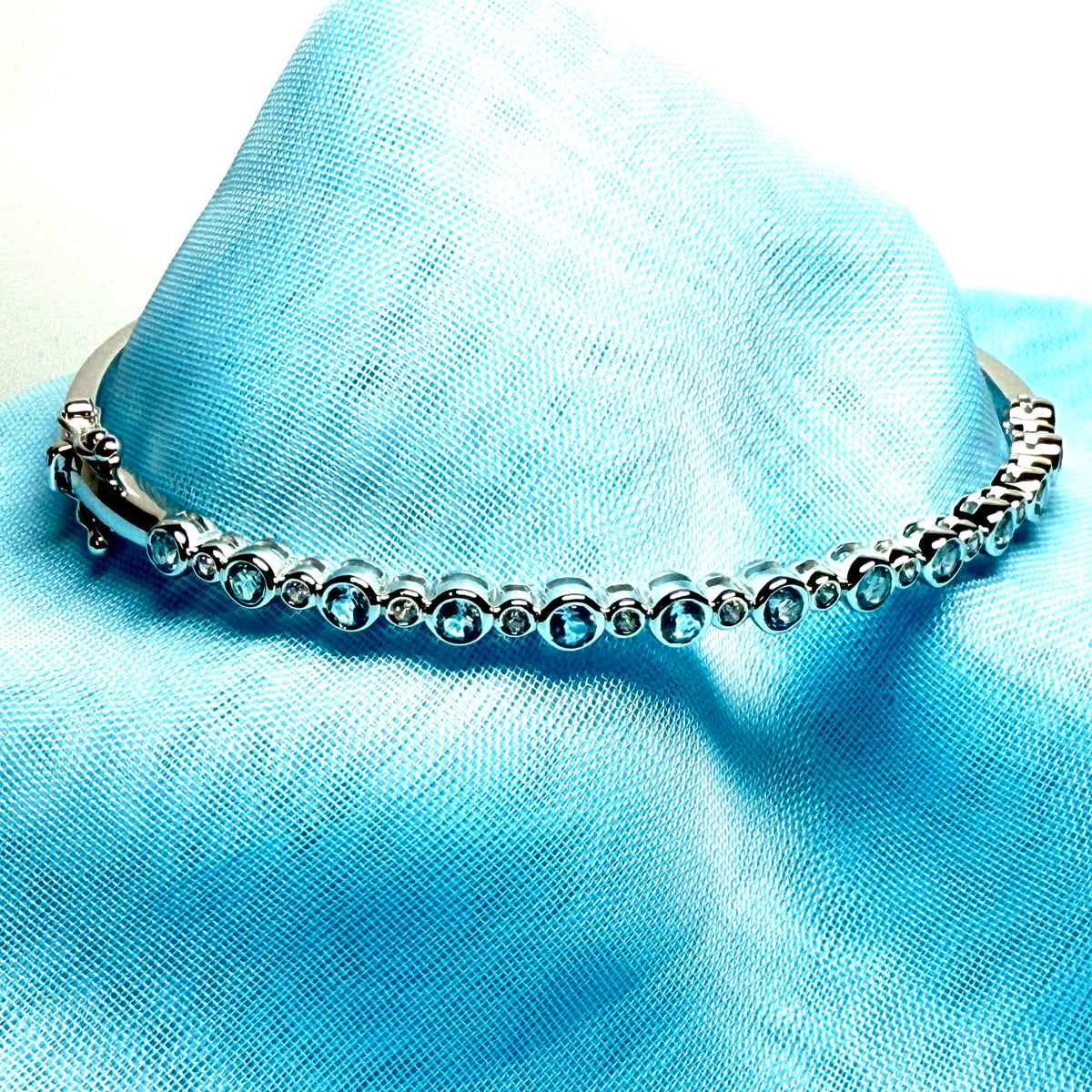 Sterling silver oval shaped real blue topaz cubic zirconia bangle