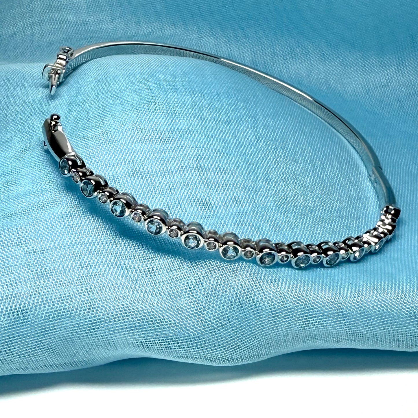Sterling silver oval shaped real blue topaz cubic zirconia bangle, open