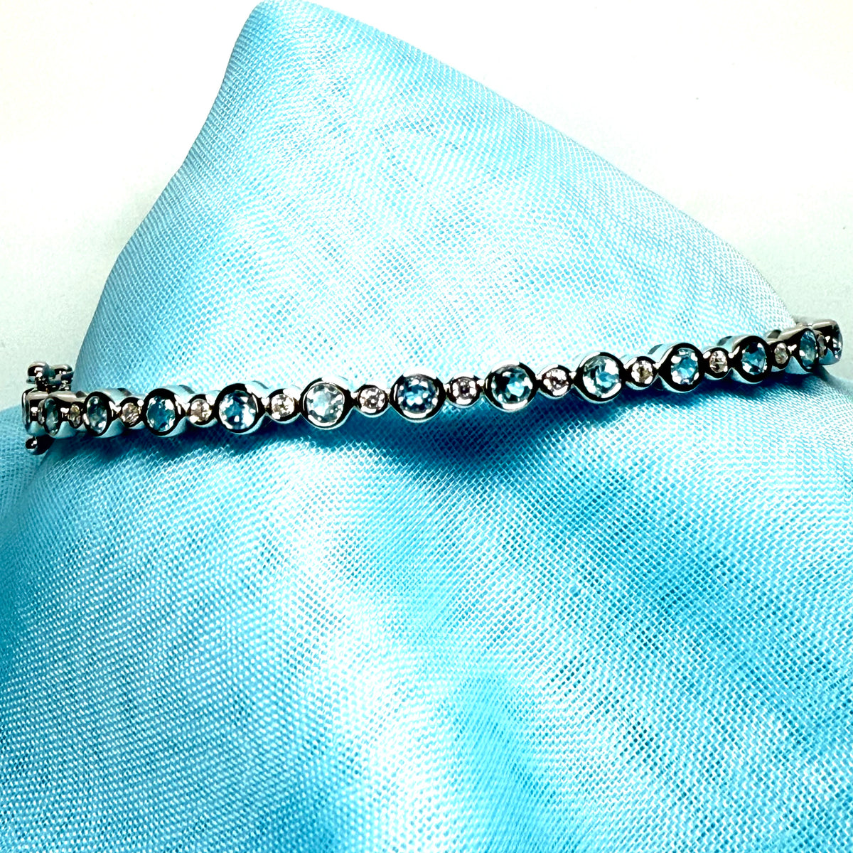 Sterling silver oval shaped real blue topaz cubic zirconia bangle