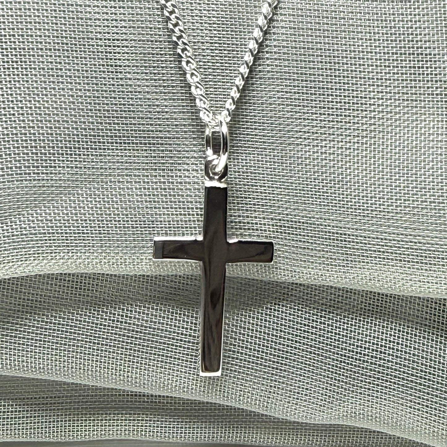 Sterling silver plain polished cross flat design with a chain