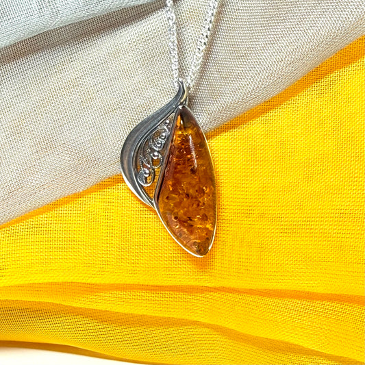 A Sterling silver real amber irregular marquise shaped necklace swirled open pendant