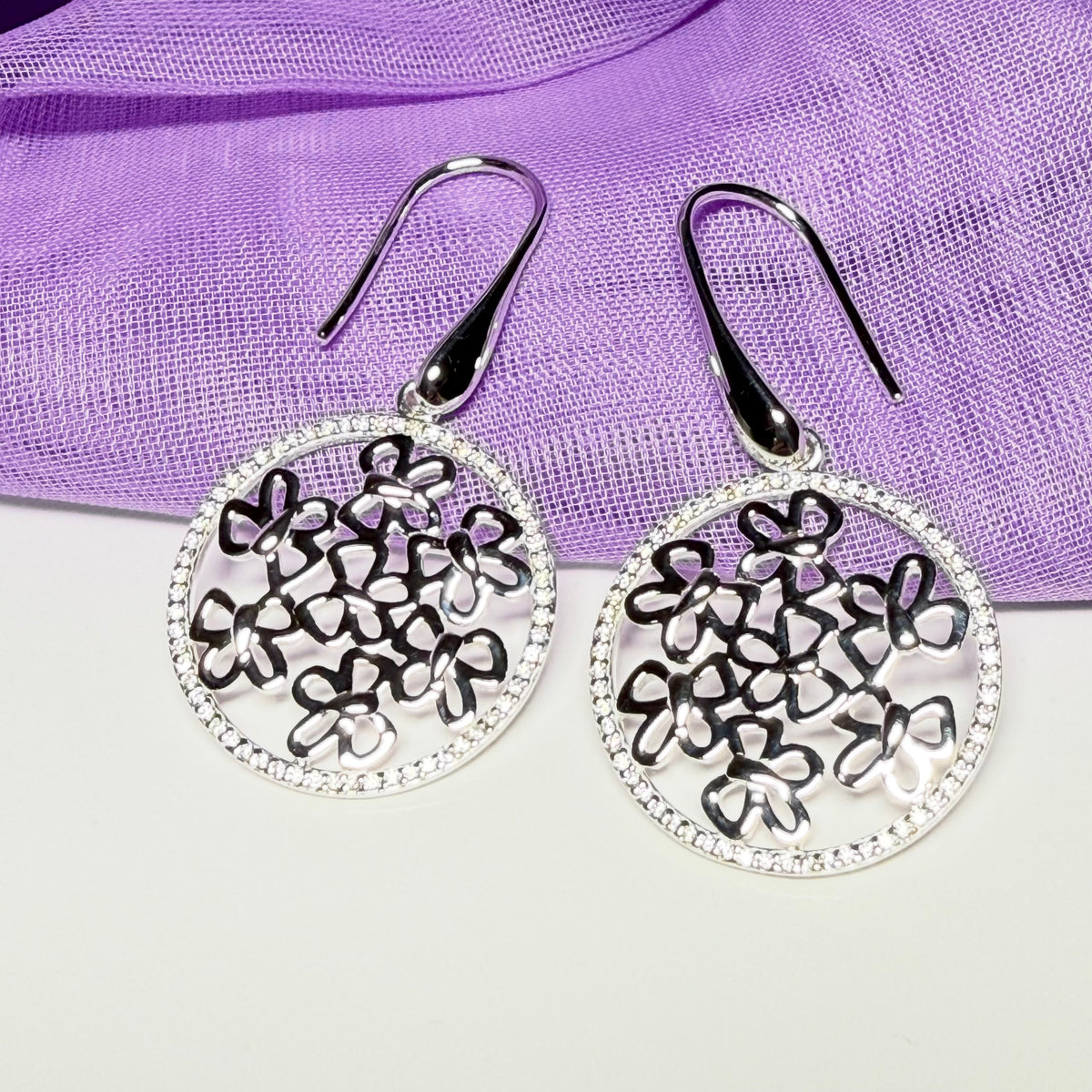 Sterling silver round shaped drop earrings with an open pierced design