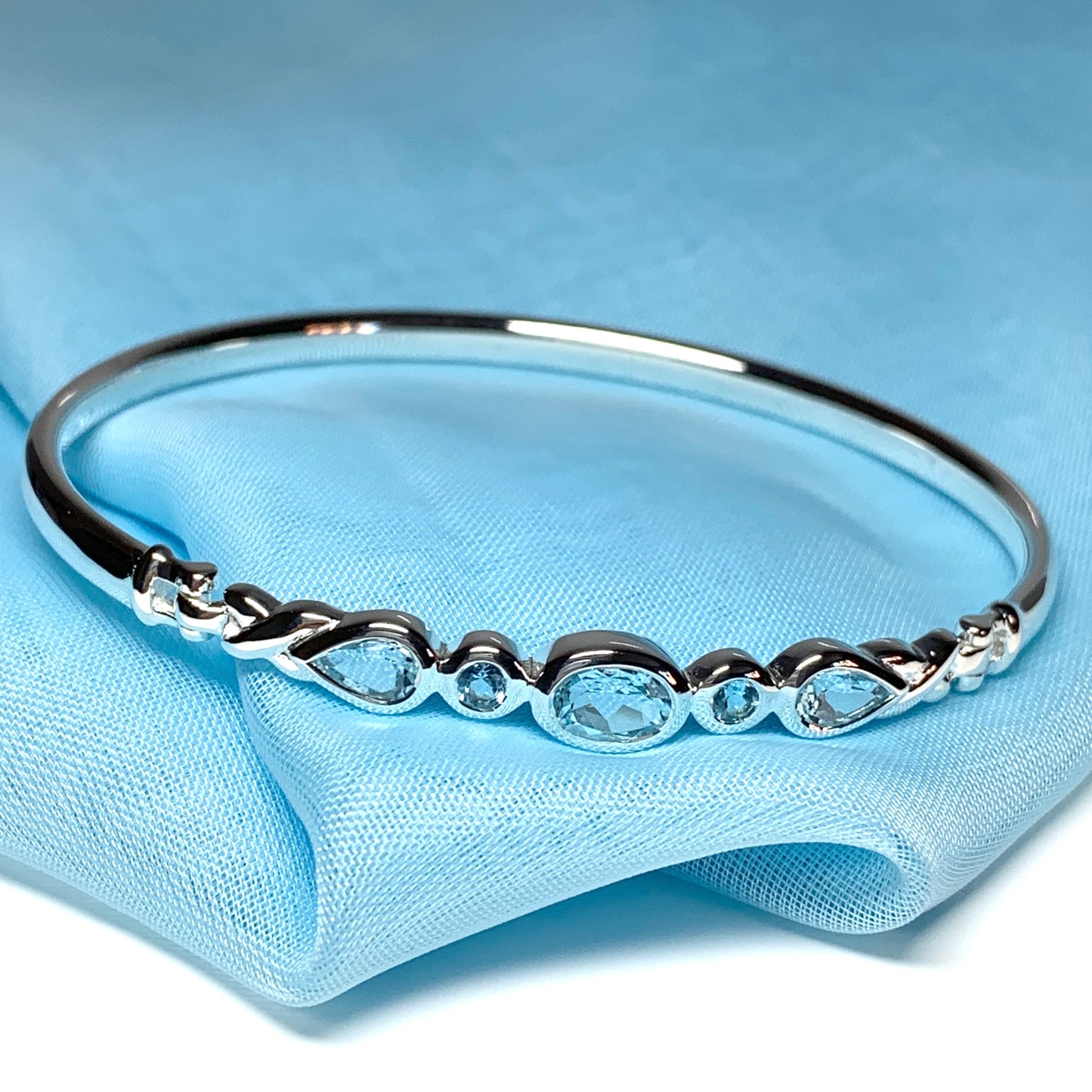 Sterling silver five stone blue topaz bangle