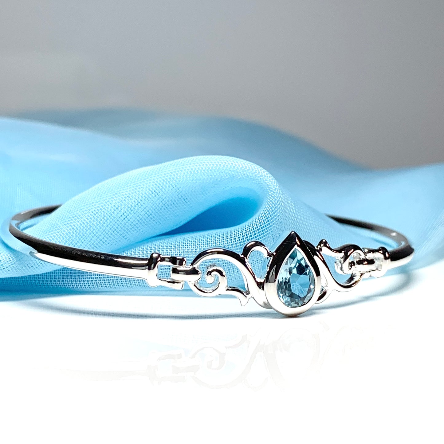 Sterling silver pear shape blue topaz bangle