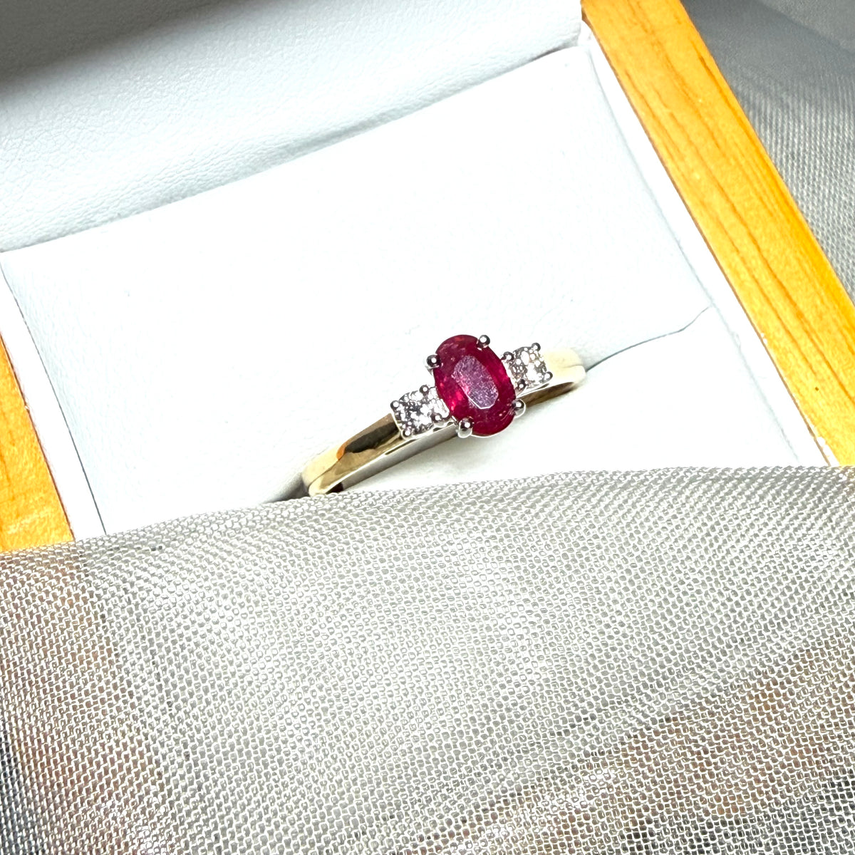 Ruby and diamond yellow gold three stone trilogy ring