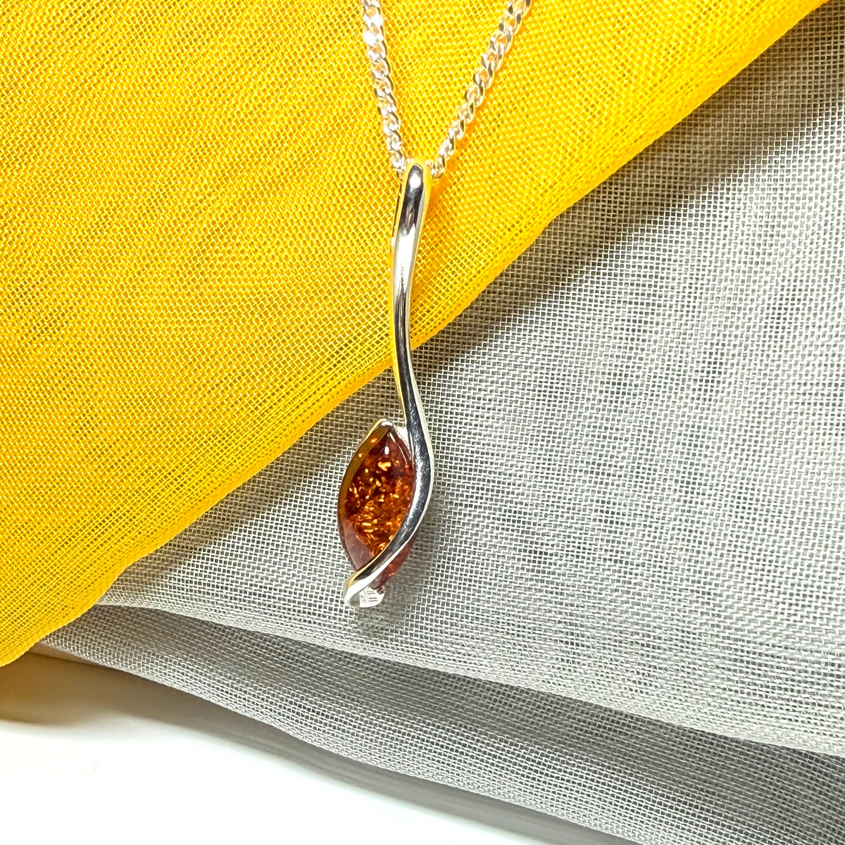A Sterling silver real amber marquise shaped necklace swirled pendant