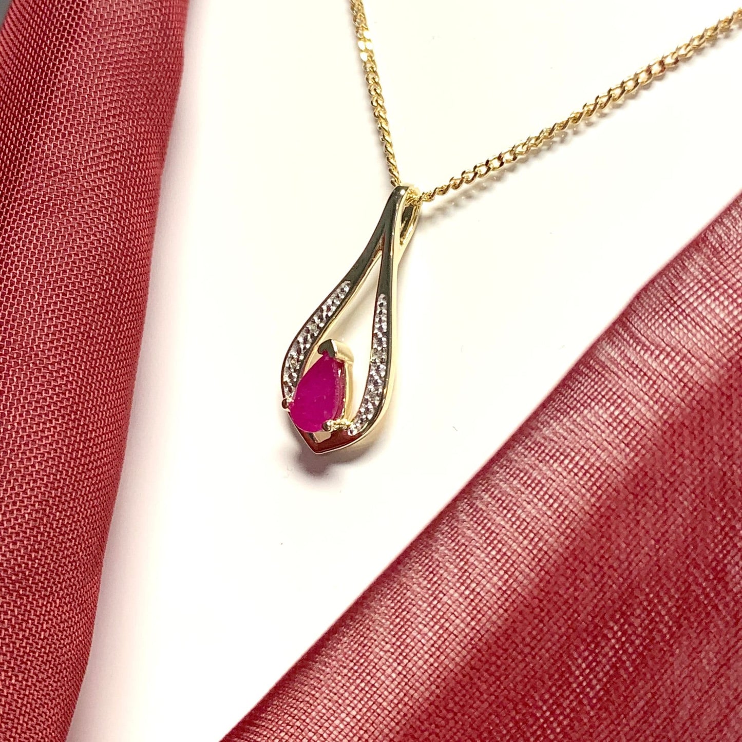 Teardrop red ruby and diamond necklace yellow gold