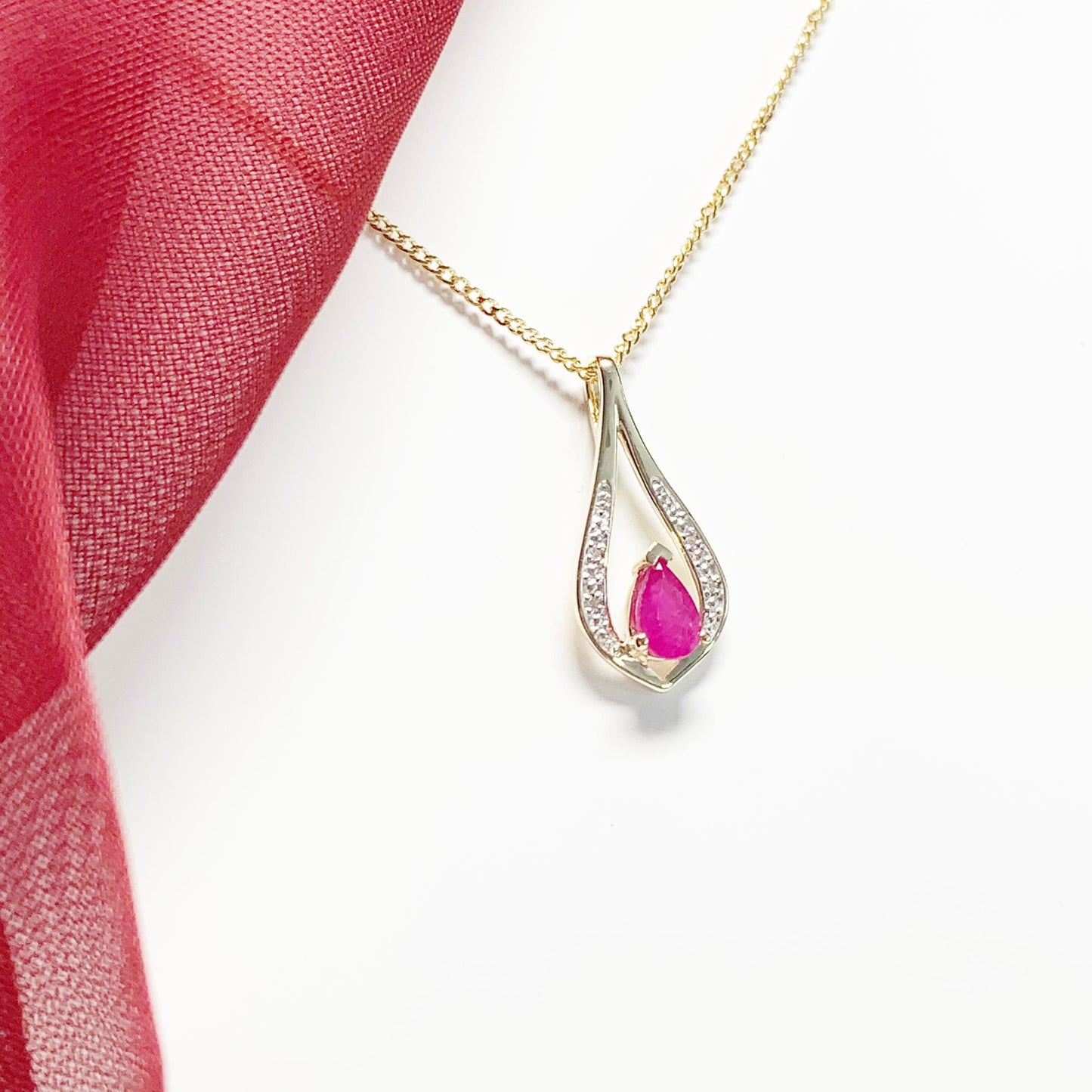 Teardrop red ruby and diamond necklace yellow gold