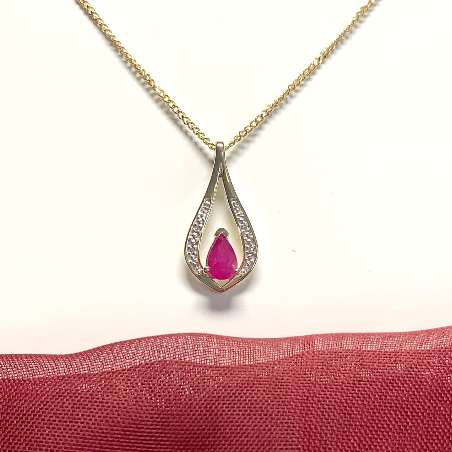 Teardrop red ruby and diamond necklace yellow gold