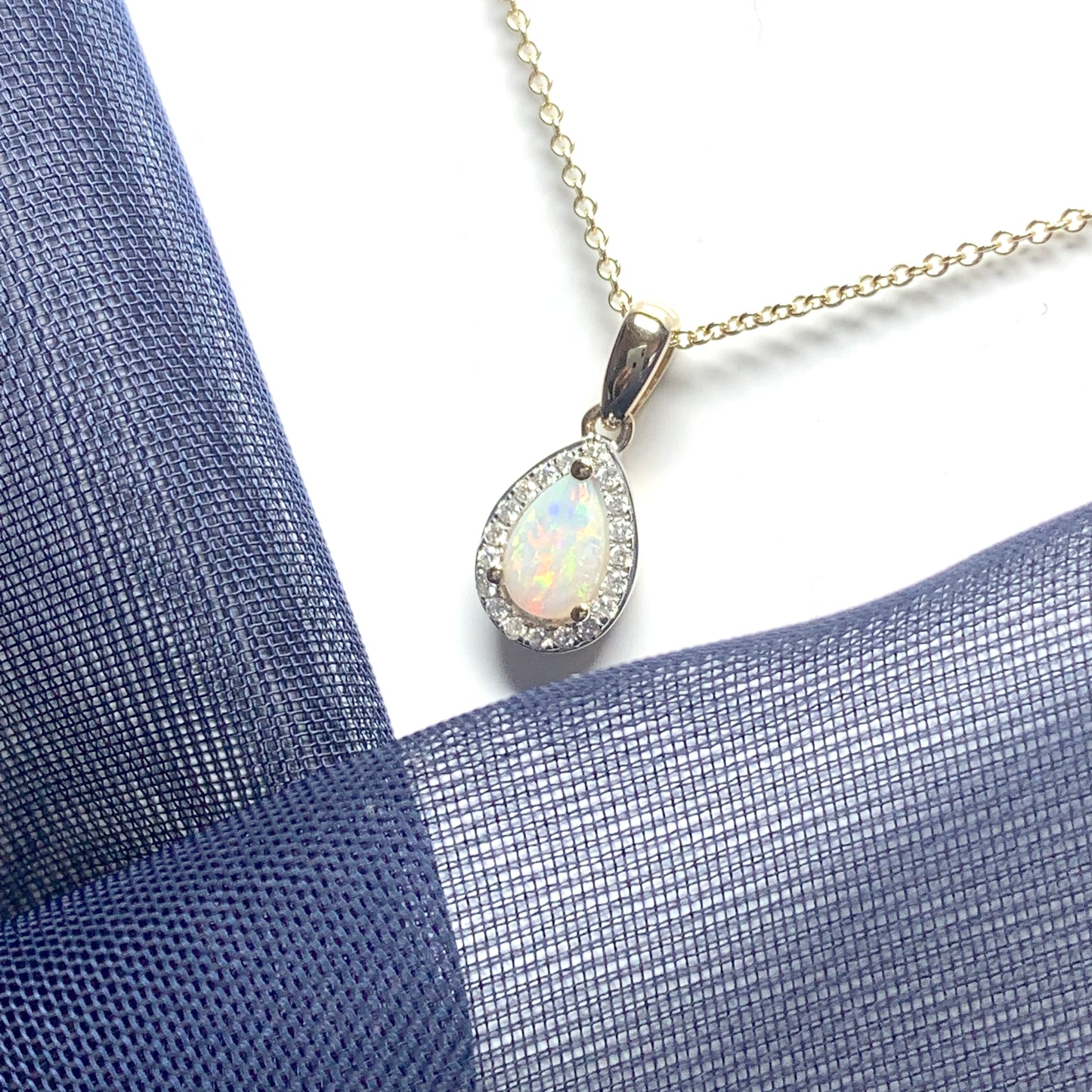Teardrop shaped opal and diamond yellow gold cluster necklace