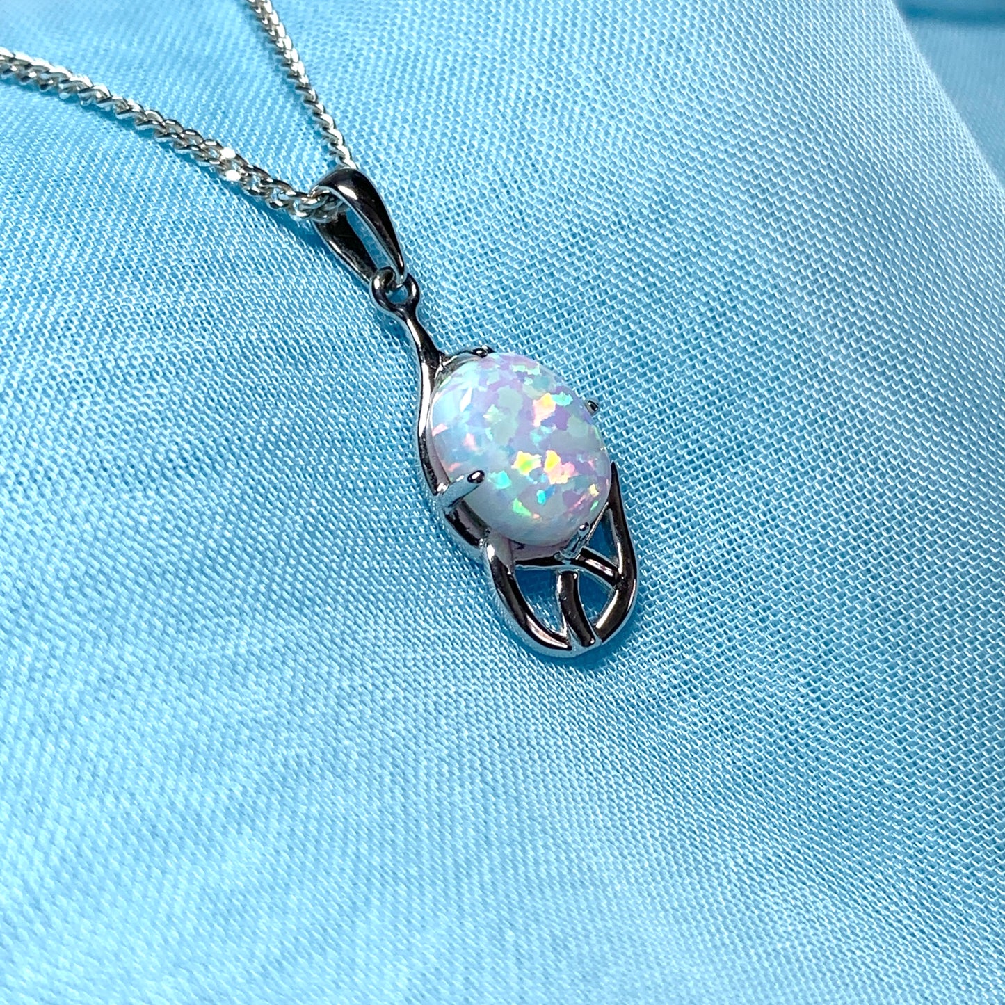 White gold celtic design oval opal necklace