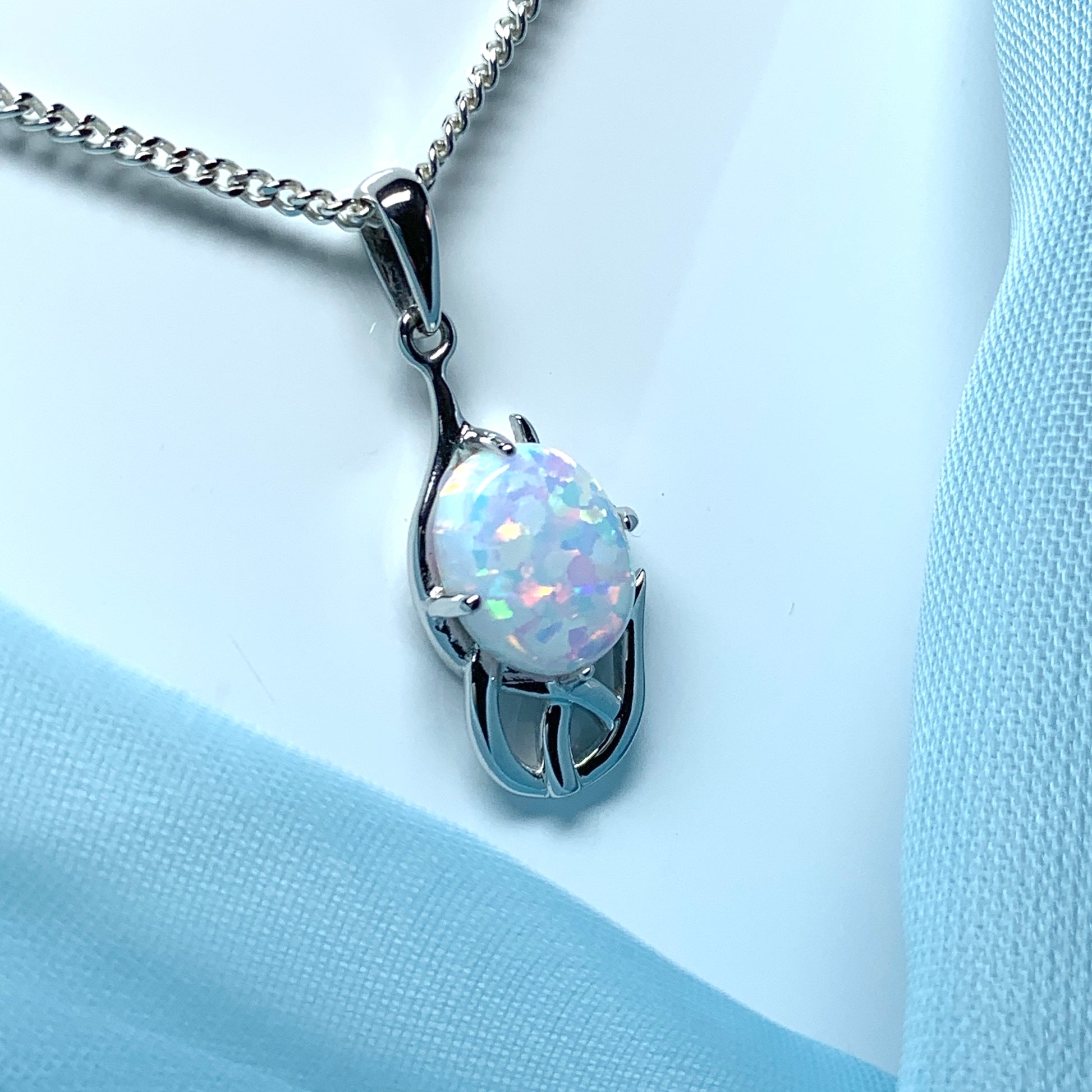 White gold celtic design oval opal necklace