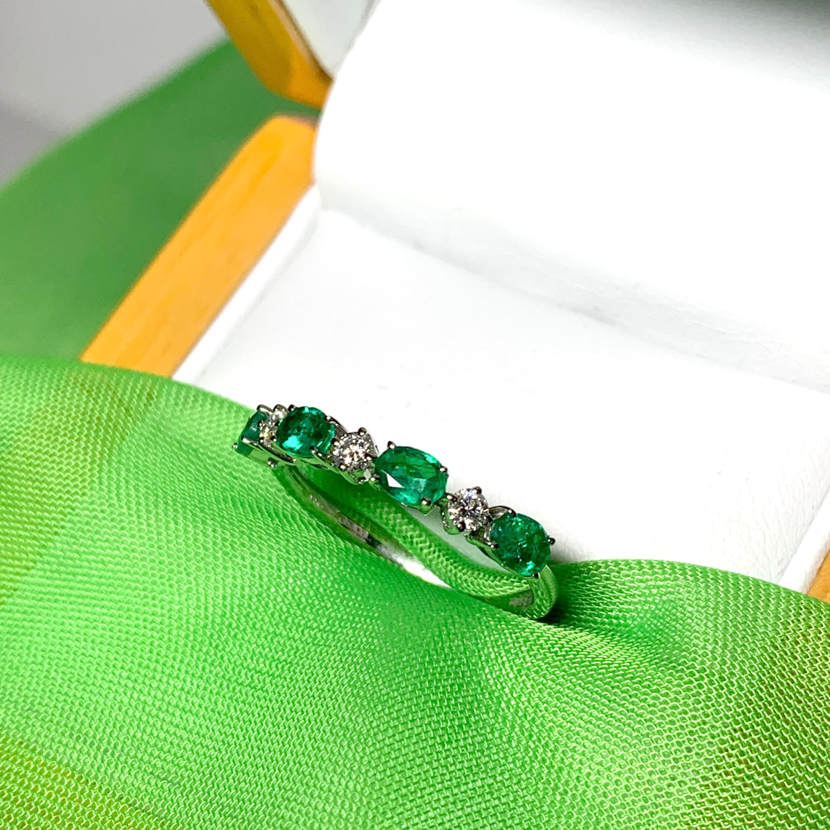 White gold oval green real emerald and diamond eternity ring