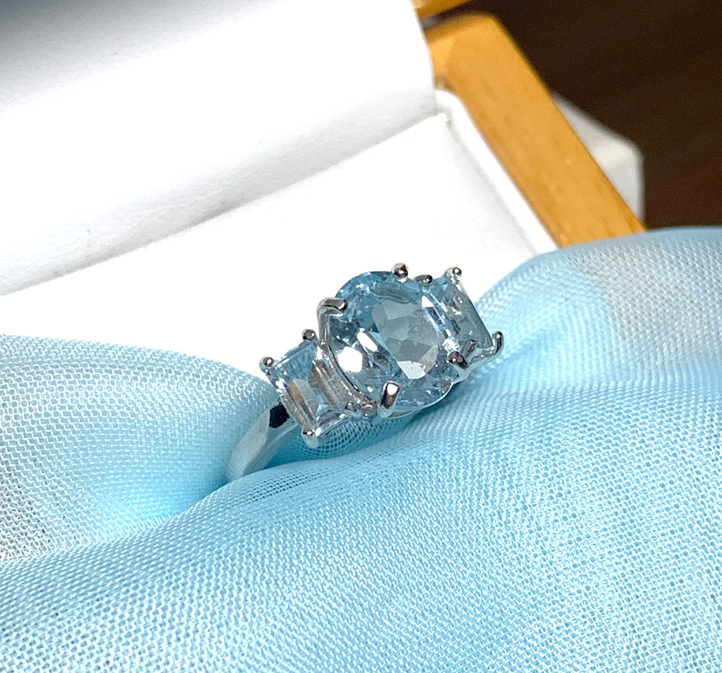 Blue topaz trilogy three stone dress ring white gold