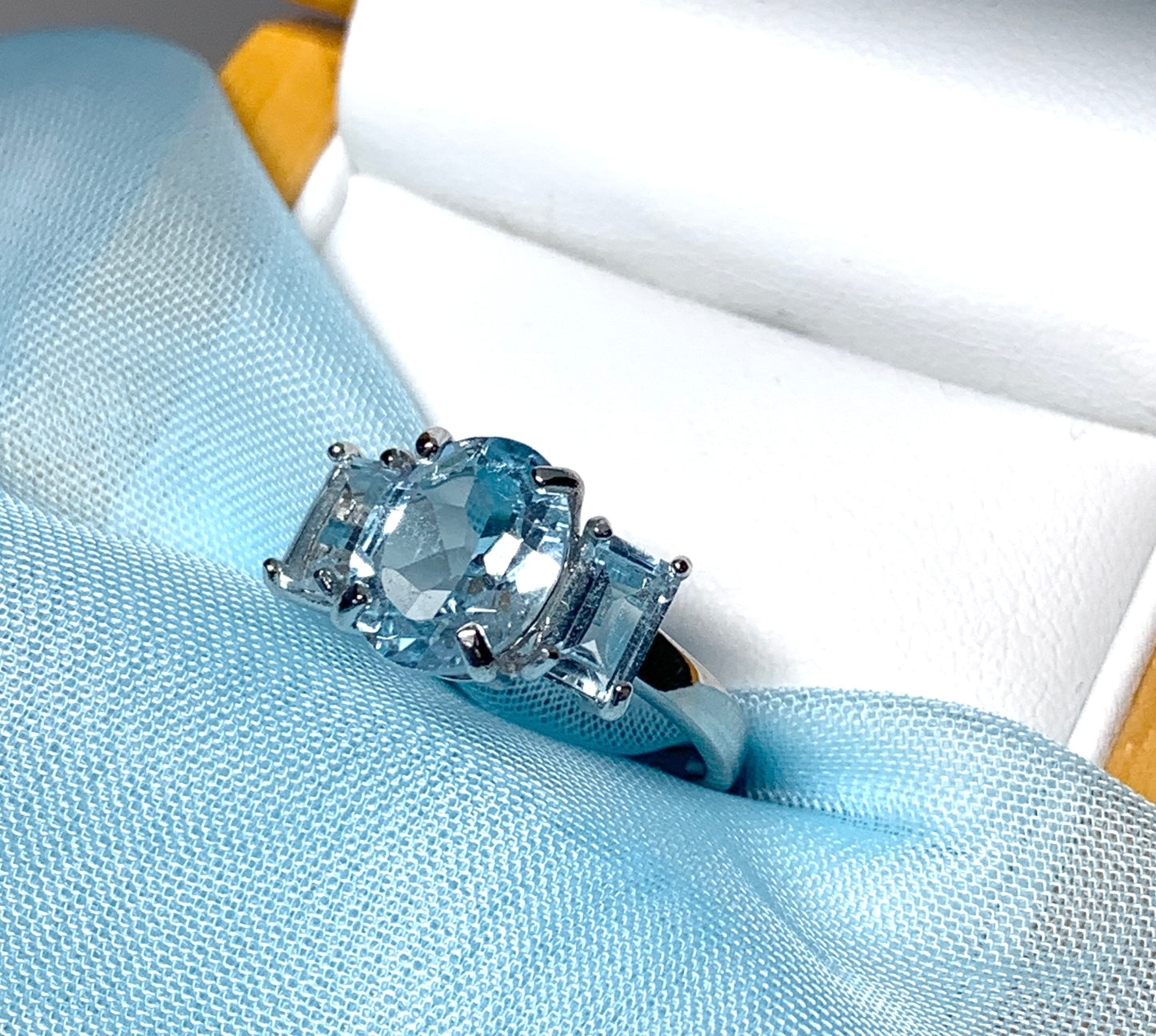 Blue topaz trilogy three stone dress ring white gold