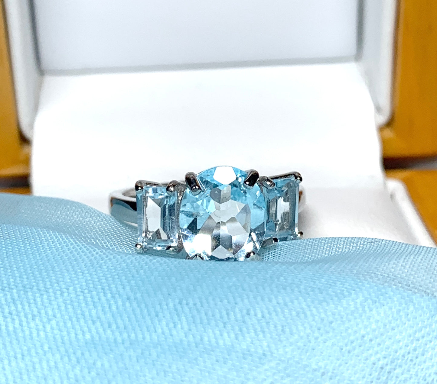 Blue topaz trilogy three stone dress ring white gold