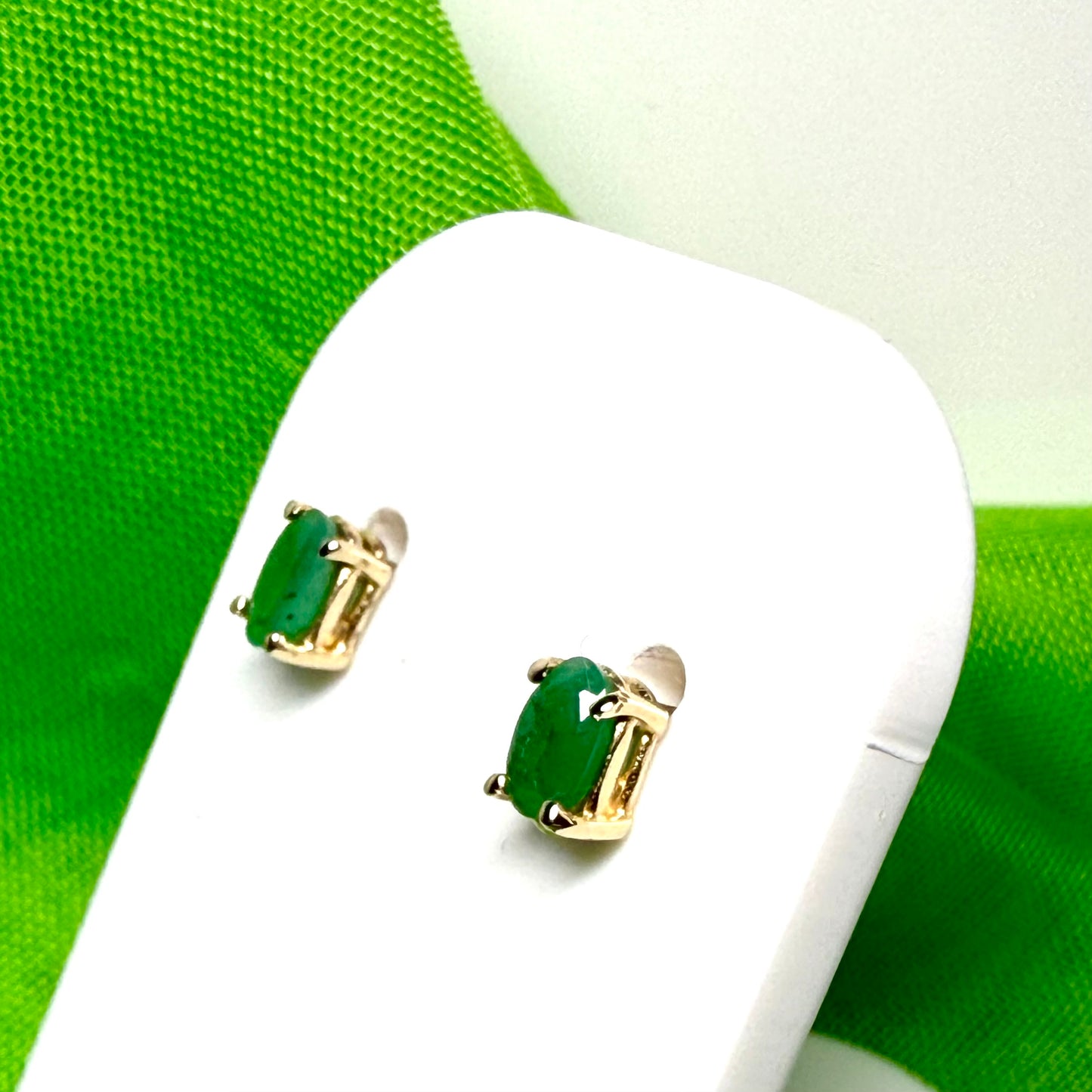 Yellow gold oval green emerald claw set stud earrings