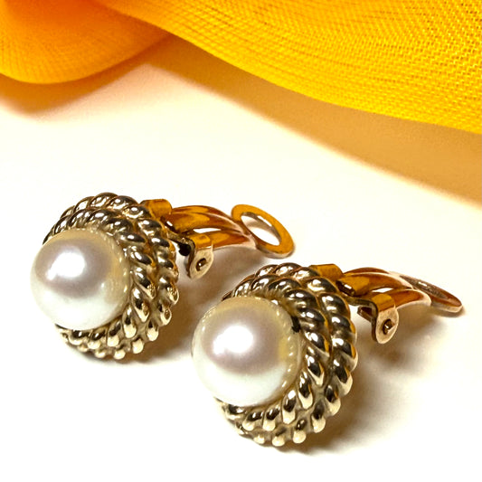 Pearl clip on earrings with gold clasps on a white background