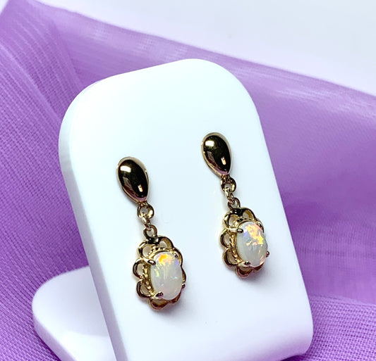 Yellow gold real opal oval drop earrings with a fancy edging