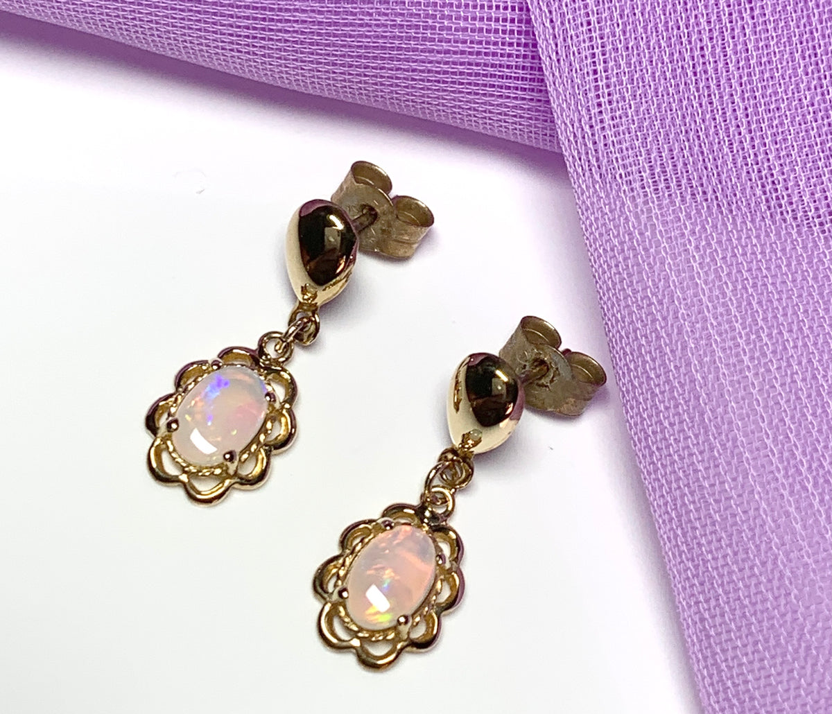 Yellow gold real opal oval drop earrings with a fancy edging