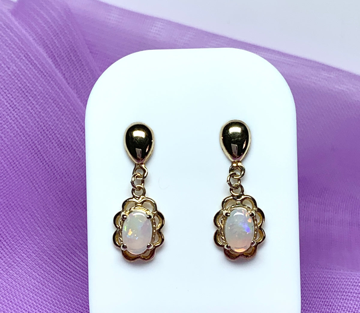 Yellow gold real opal oval drop earrings with a fancy edging