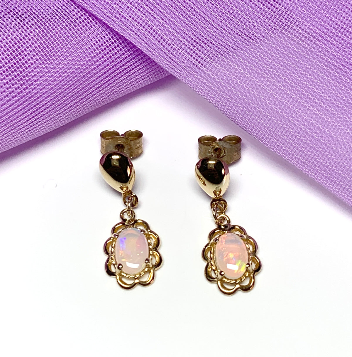 Yellow gold real opal oval drop earrings with a fancy edging