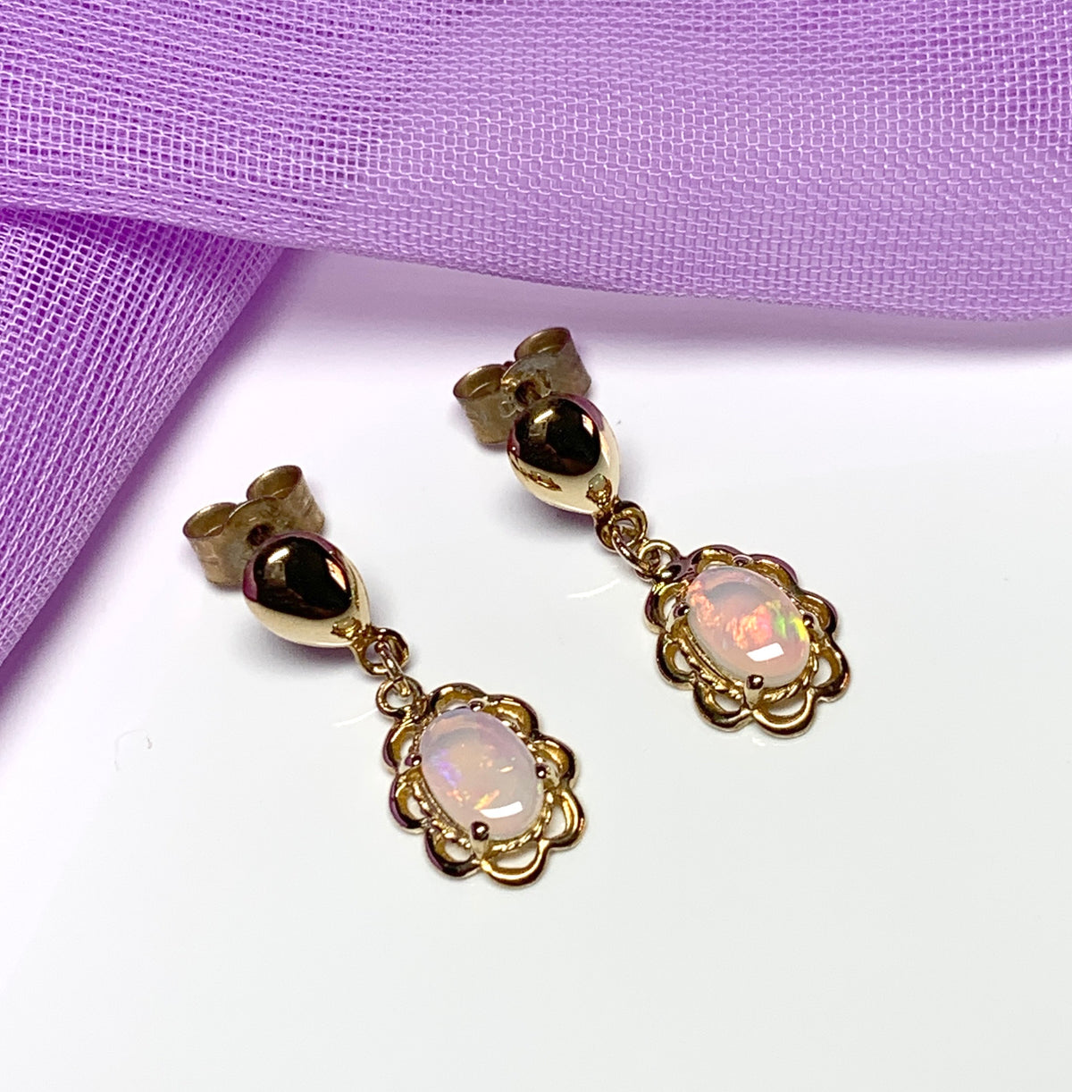 Yellow gold real opal oval drop earrings with a fancy edging