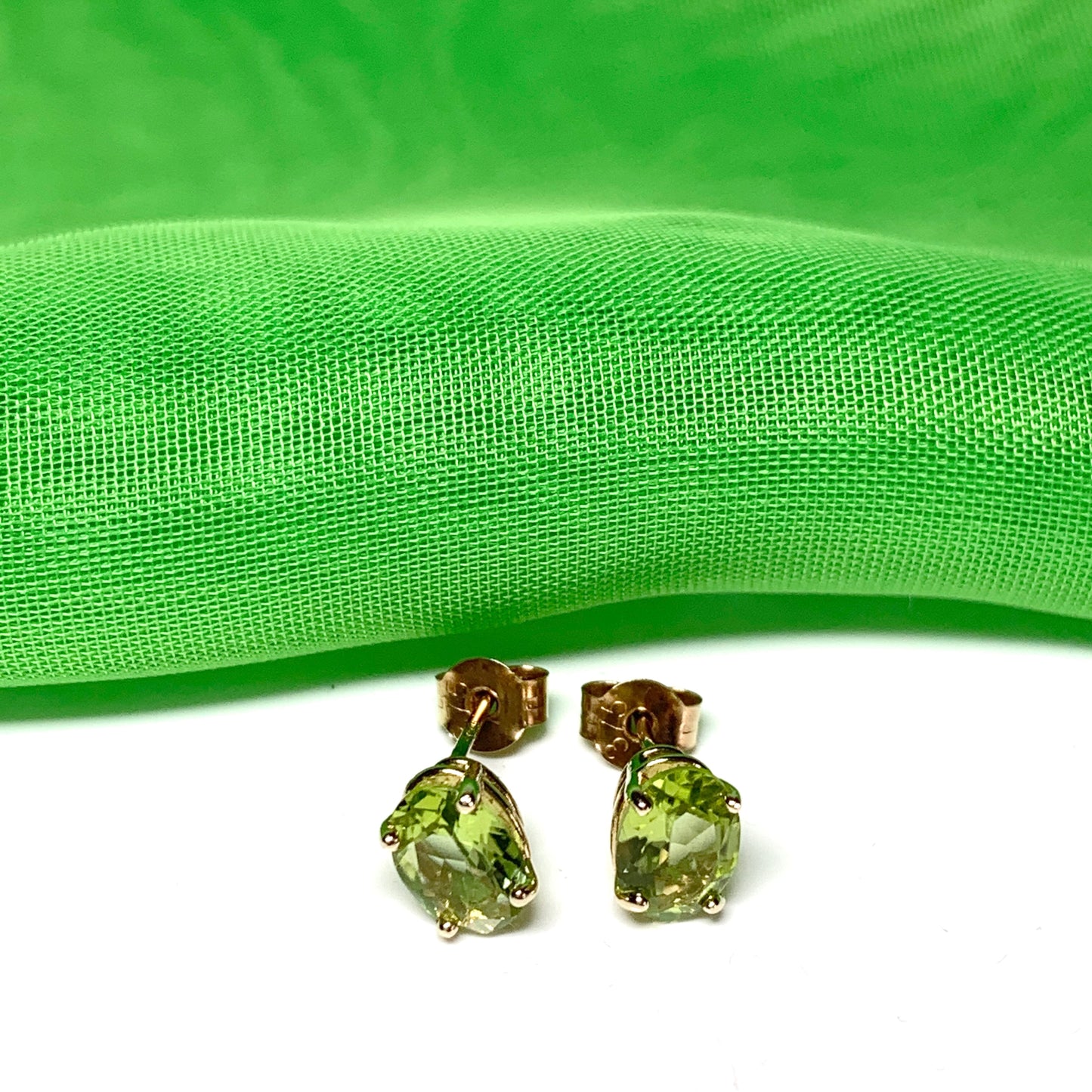 Yellow gold peridot oval stud earrings