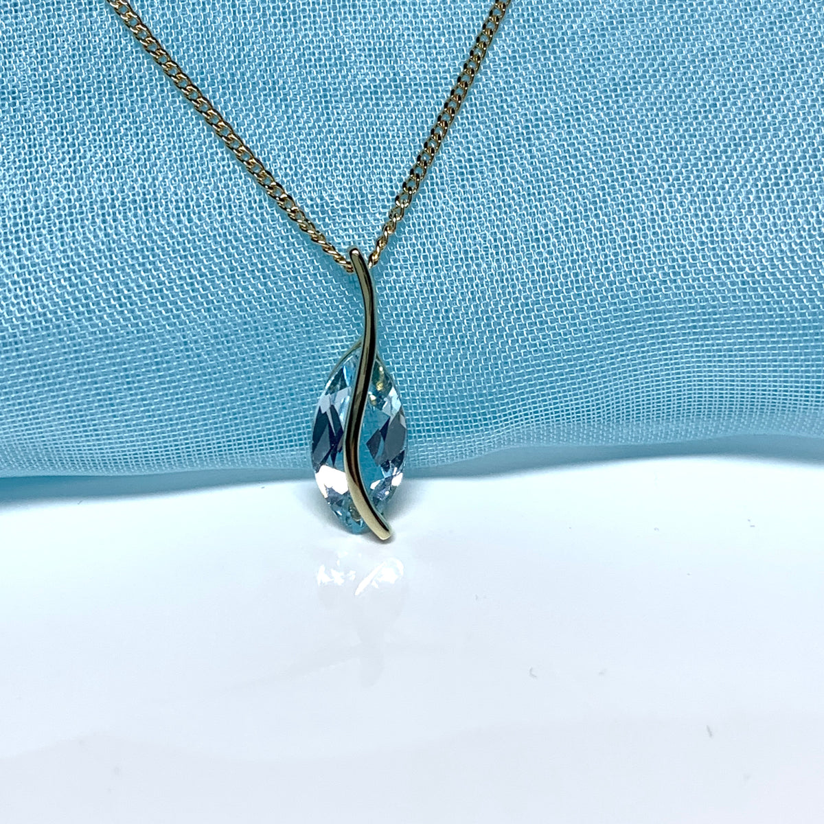 Yellow gold real blue topaz fancy swirl marquise shaped necklace pendant