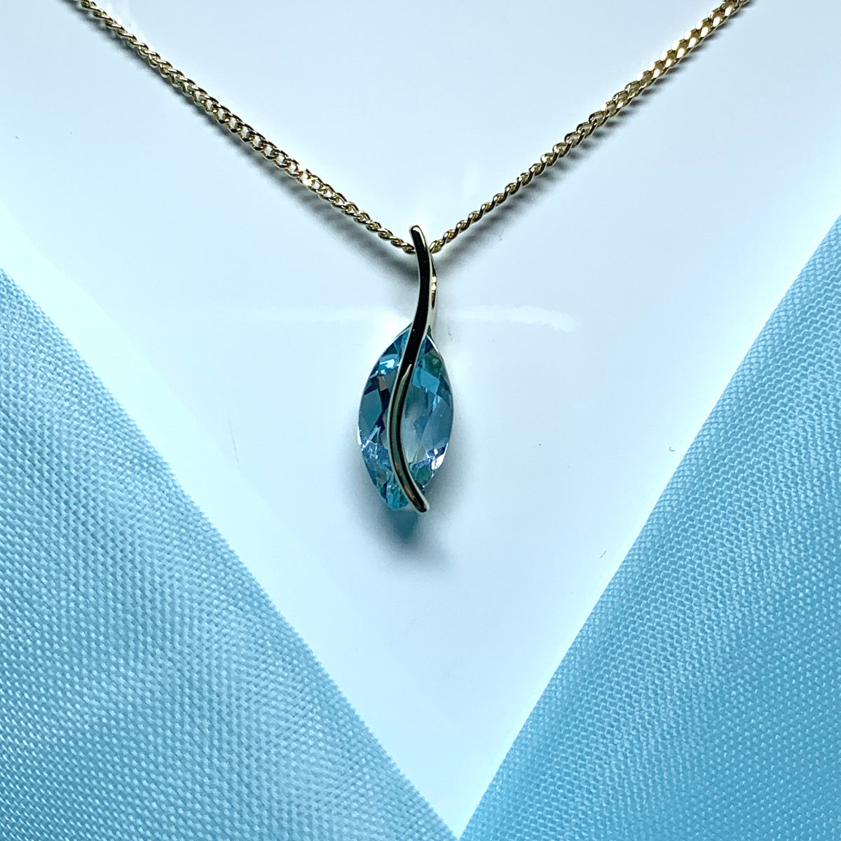 Yellow gold real blue topaz fancy swirl marquise shaped necklace pendant