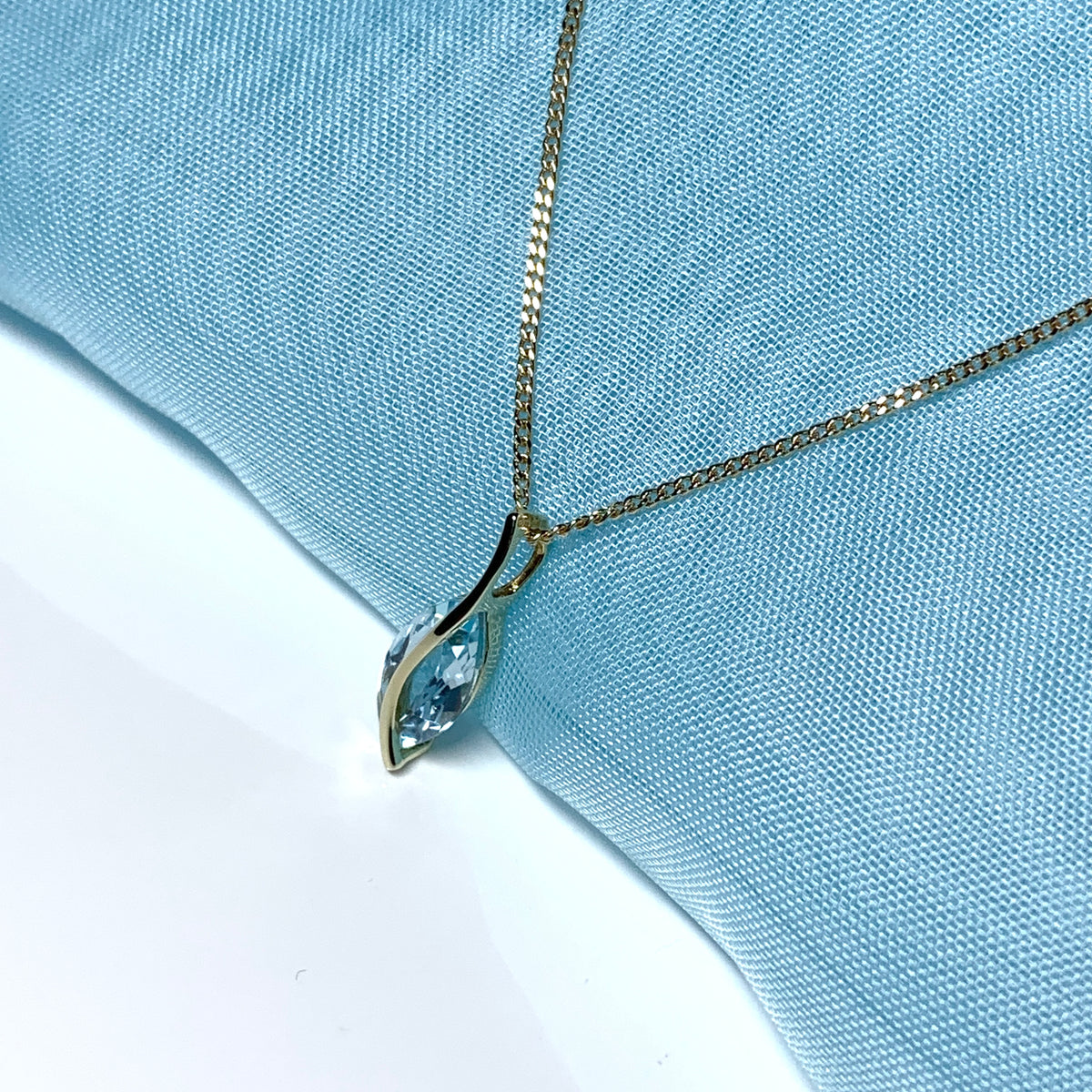 Yellow gold real blue topaz fancy swirl marquise shaped necklace pendant