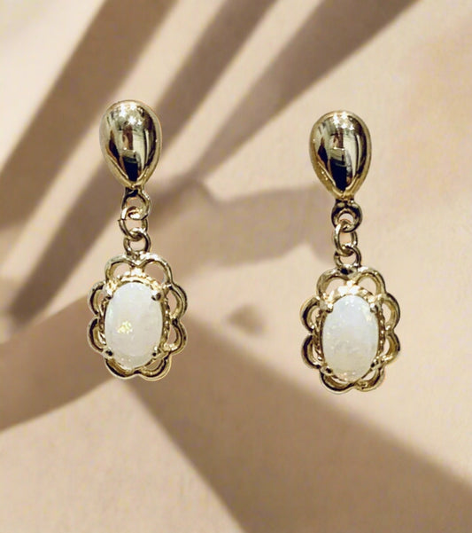 Yellow gold real opal oval drop earrings with a fancy edging