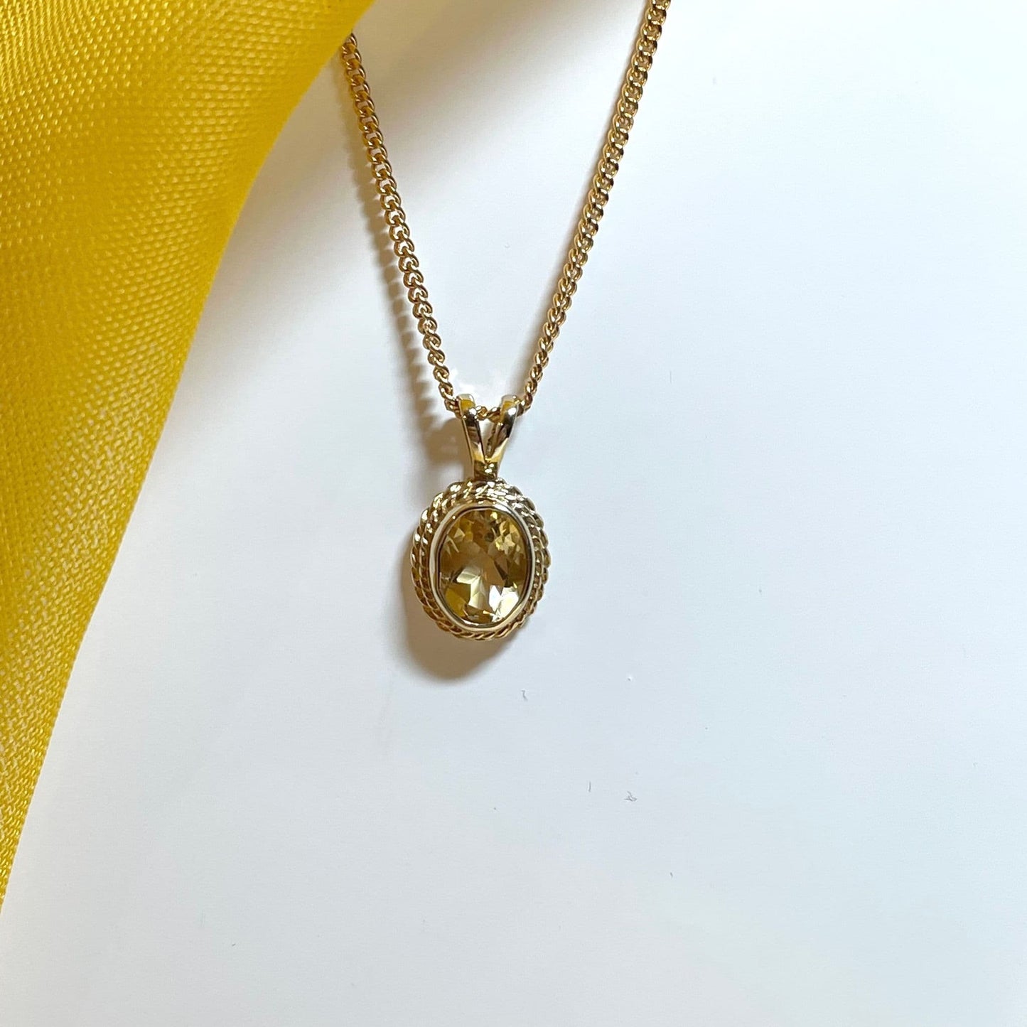 An oval yellow gold citrine necklace