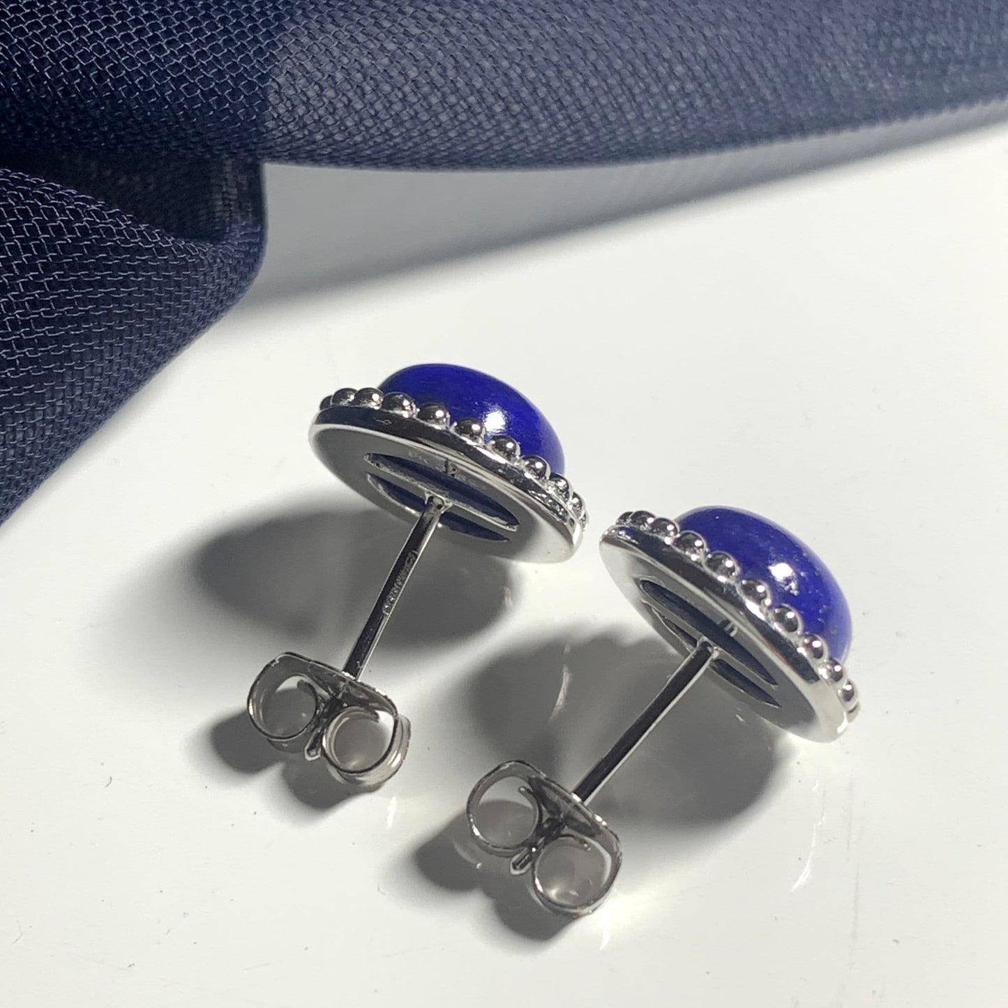 Round dark blue lapis lazuli white gold stud earrings