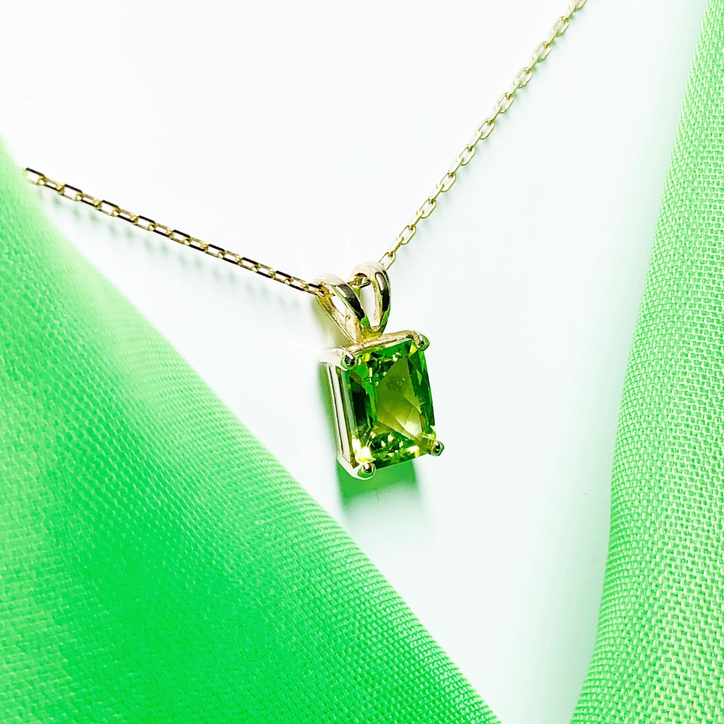 Peridot yellow gold claw set rectangle necklace