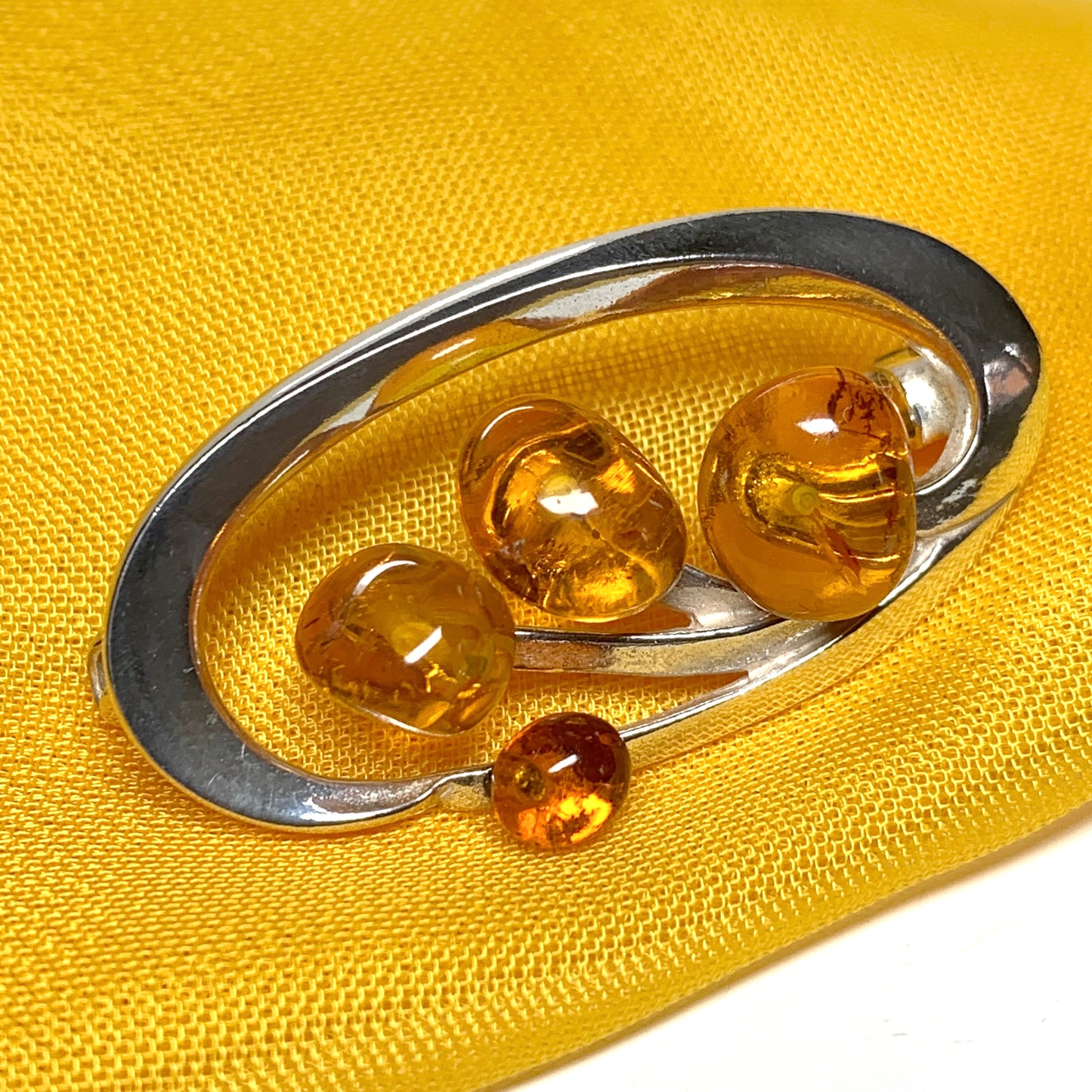 Sterling silver oval swirl fancy amber brooch