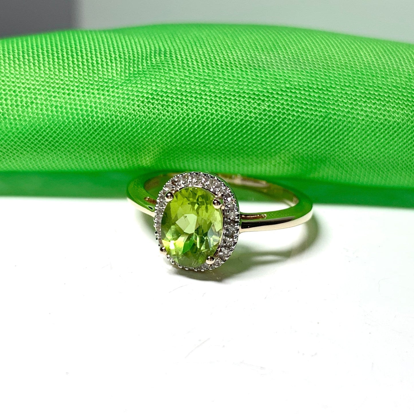 Peridot and diamond yellow gold oval cluster ring