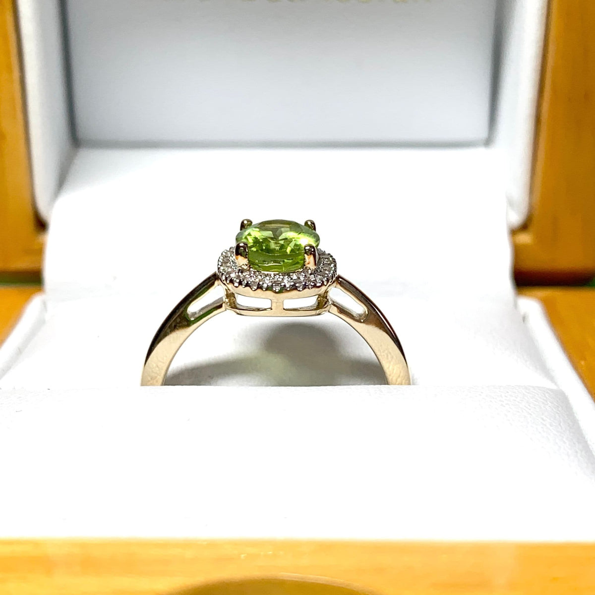 Peridot and diamond yellow gold oval cluster ring