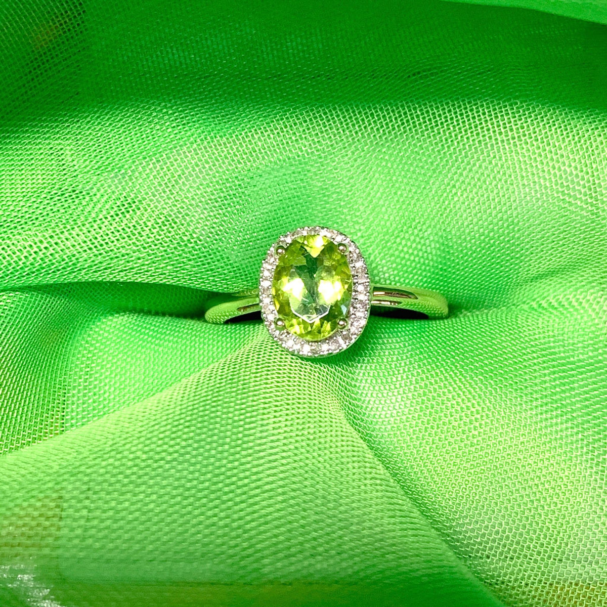 Peridot and diamond yellow gold oval cluster ring